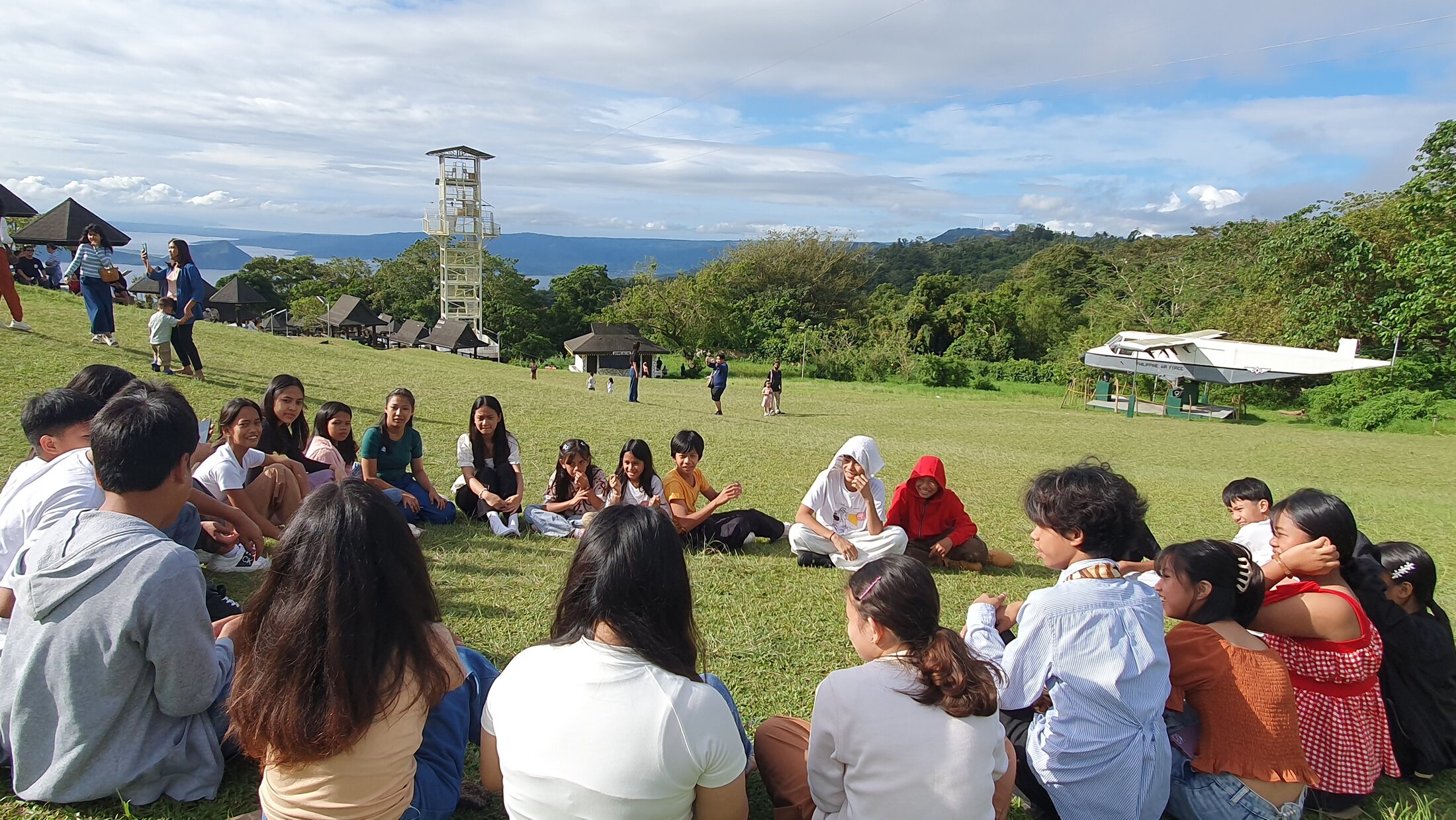 A group sharing an outdoor circle gathering
